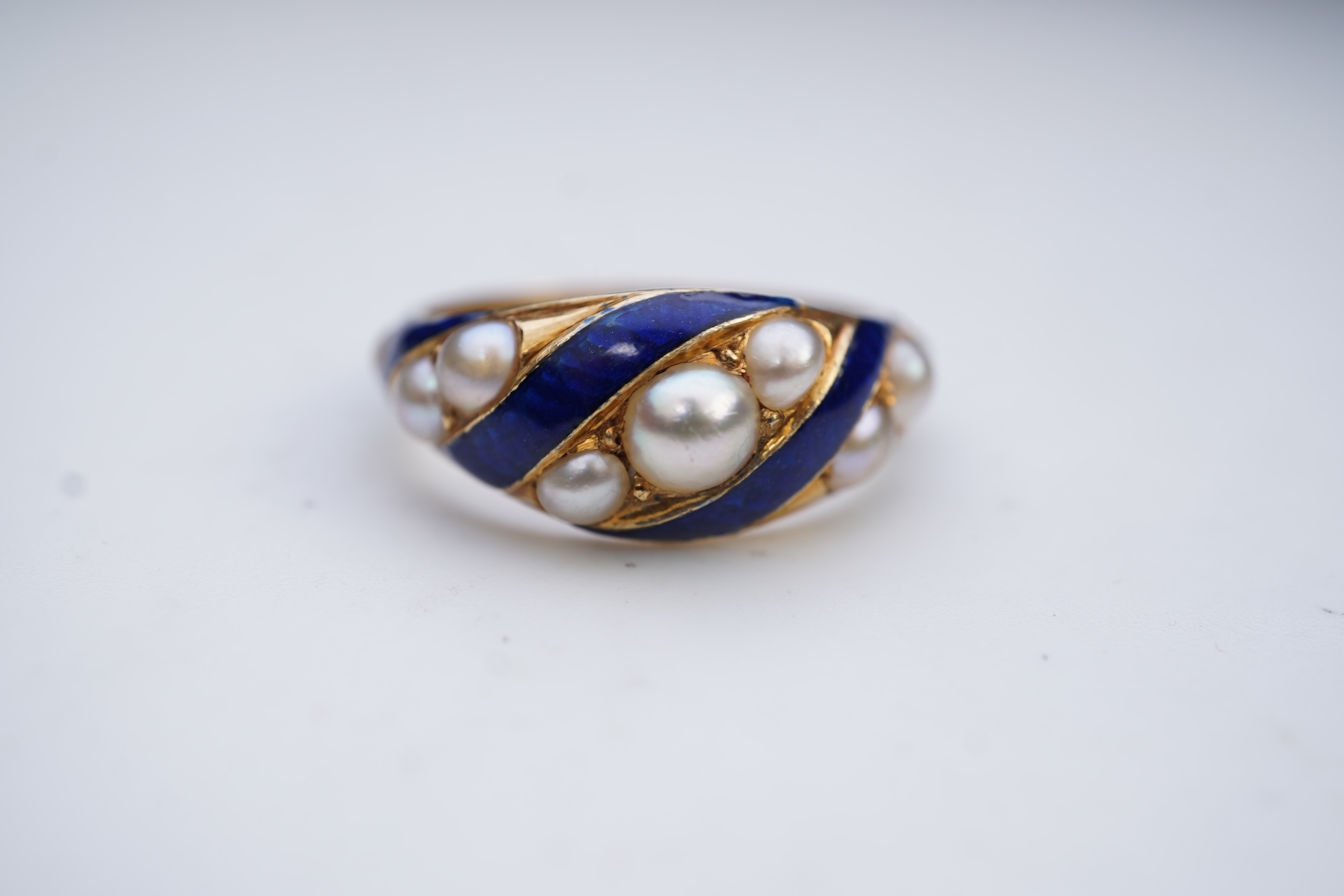 A Victorian half pearl and blue enamel ring, mid 19th century